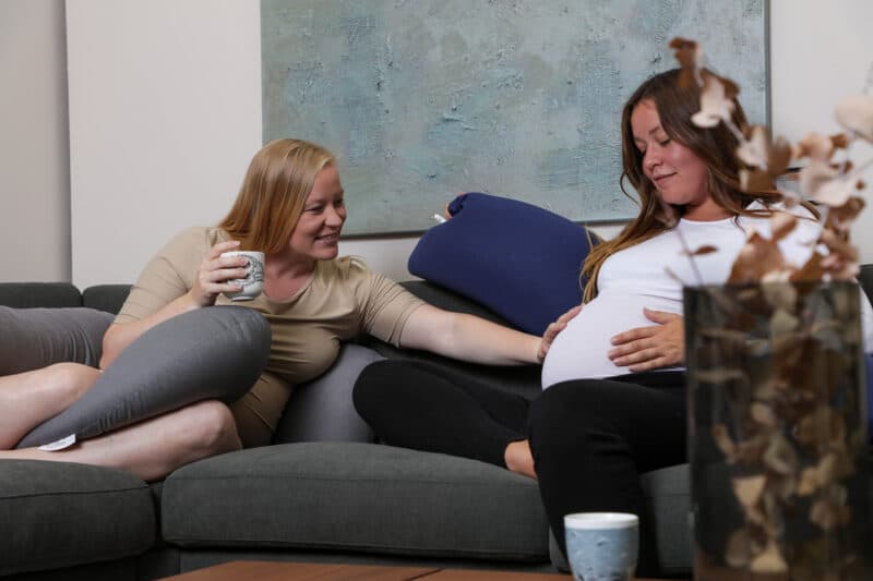 two women and blue pregnancy pillow